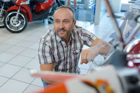 a motorcycle mechanic in workshopの写真素材