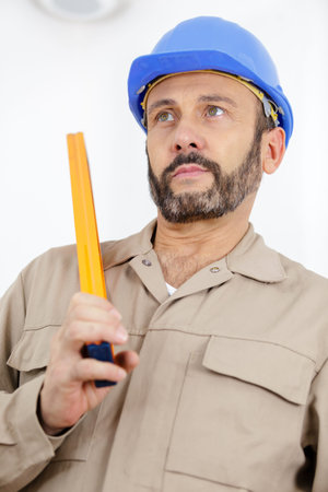 male builder in a helmet looking ahead