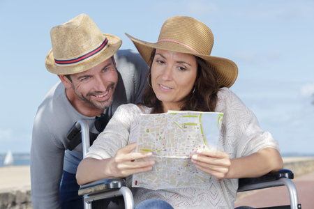 couple in wheelchair looking at map