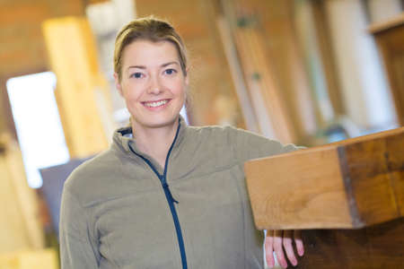 female woodworking worker posing smilingの写真素材