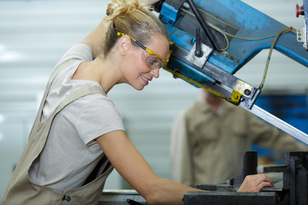 beautiful woman using industrial machinery