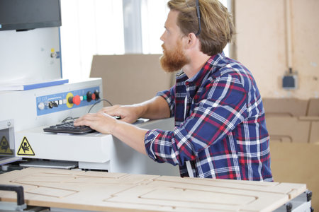 operator cutting wood using special machine