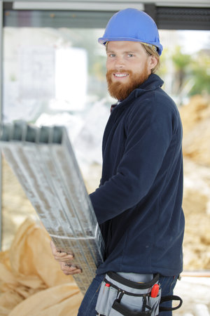 a happy worker carrying load