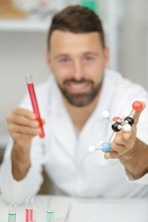 happy male scientist working in laboratory