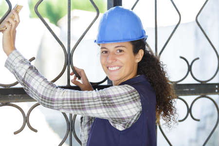young professional construction worker using sandpaperの写真素材