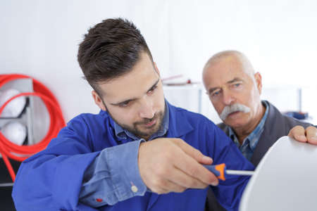 male machinist working on machine partの写真素材