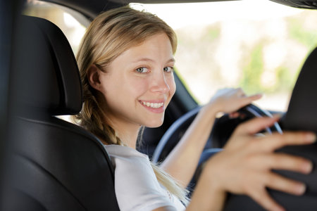a girl looking back in her car