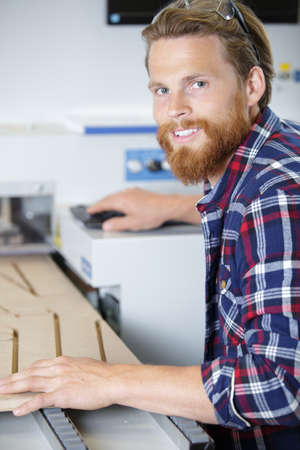 young happy man using a wood shaperの写真素材