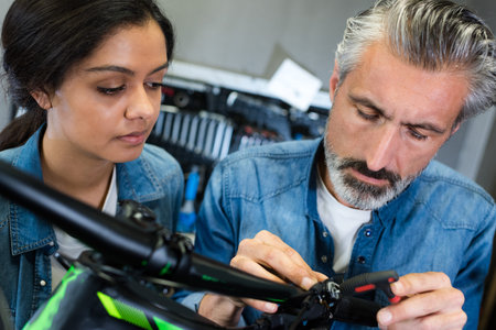 positive guy and girl hiring bikes ot rental store