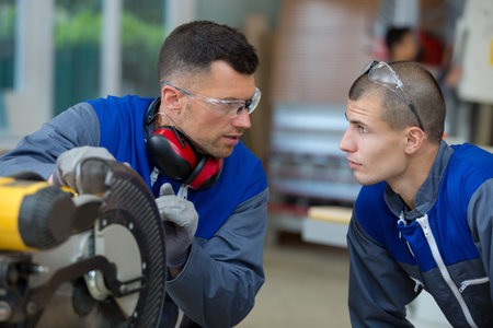 apprentice learning to use circular saw