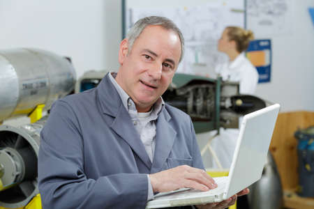 mature male technician using laptop mature male technician using laptop