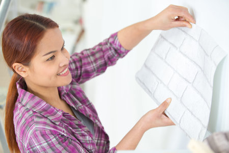 smiling woman builder worker holds blueprint