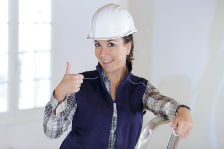 a woman builder showing thumb-up