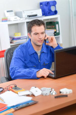 Electrician working at his desk