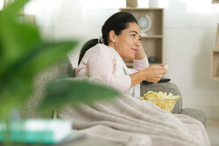 woman eating chips at home