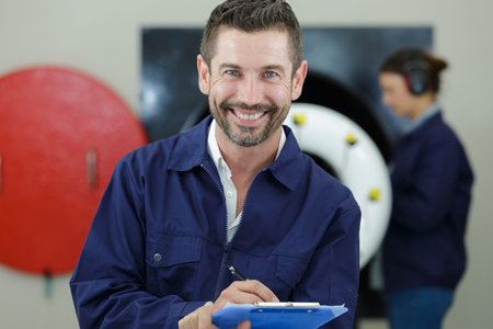 happy foreman stood in front of the camera