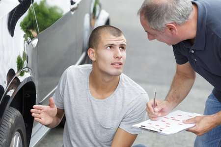 car technician checking auto after breakdown