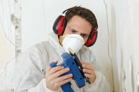 working man with sanding machine sandsの写真素材