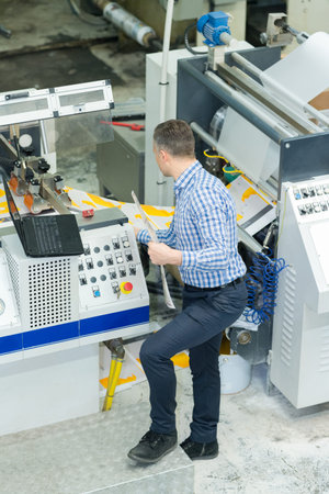 man working with printing machine