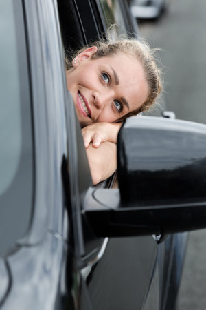 young woman dreaming in the car looking out of window