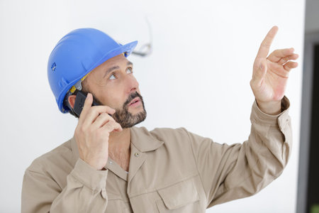 male construction worker using mobile phone