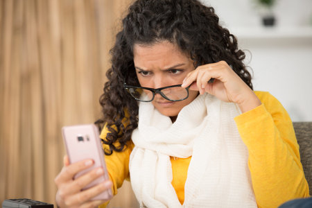 clueless looking girl having troubles with her smartphone