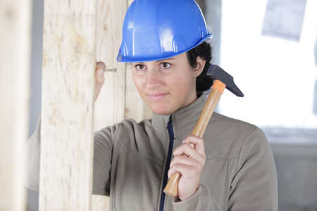 a woman builder with a hammerの写真素材