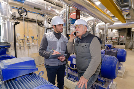 portrait of two workers in factory