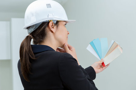 female interior designer picking the right color for the wall