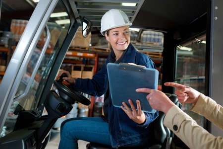 female forklift operator receiving odersの写真素材