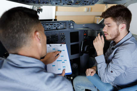 portrait of male aero engineers with clipboardの写真素材