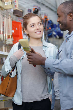 a female customer buying paint brushesの写真素材