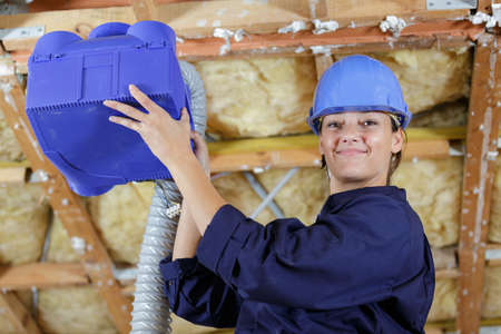 installing a blue ventilation boxの写真素材