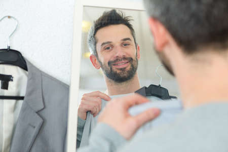 bearded man which tries on a suitの写真素材