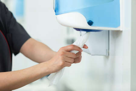 taking paper from tissue dispenserの写真素材