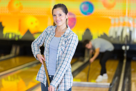 portrait of woman cleaning bowling alley