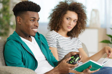 woman is annoyed with her boyfriend playing computer game
