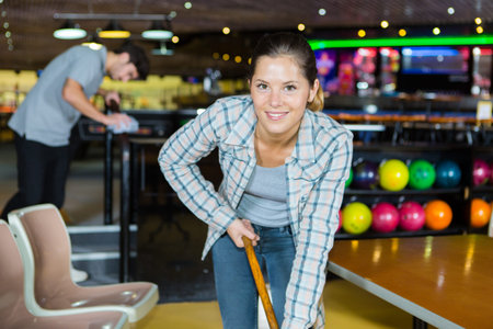 woman cleaning in bowling alley