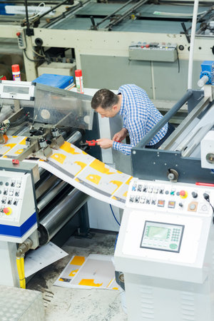 man worker near printing machine