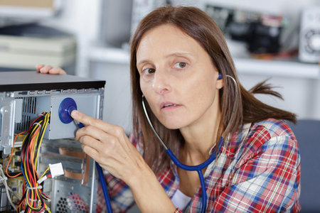woman holding stethoscope repair computer motherboard