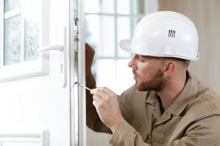 man fixing the door handle with screwdriver