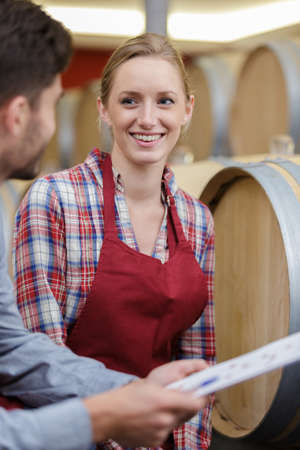 female cellar and barrel worker receiving orderの写真素材