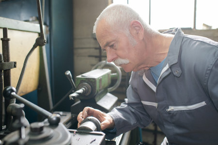 senior carpenter working at workshopの写真素材