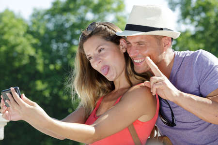 young couple taking wacky pictureの写真素材