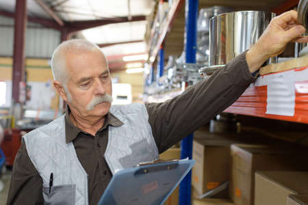 senior manager check stock in the warehouseの写真素材