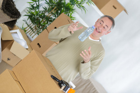 Portrait of man packing boxes