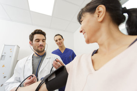 doctor taking patients blood pressure