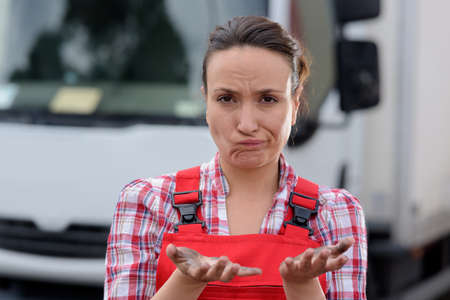 female worker showing dirty hands and making rueful facial expressionの写真素材