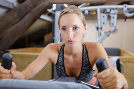 woman biking in the gym
