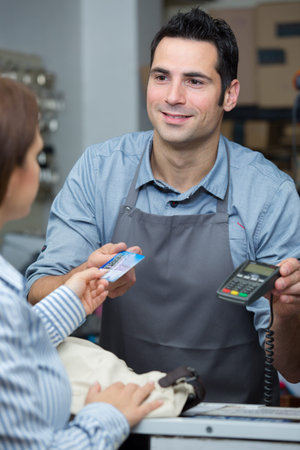 client giving her card for service payment